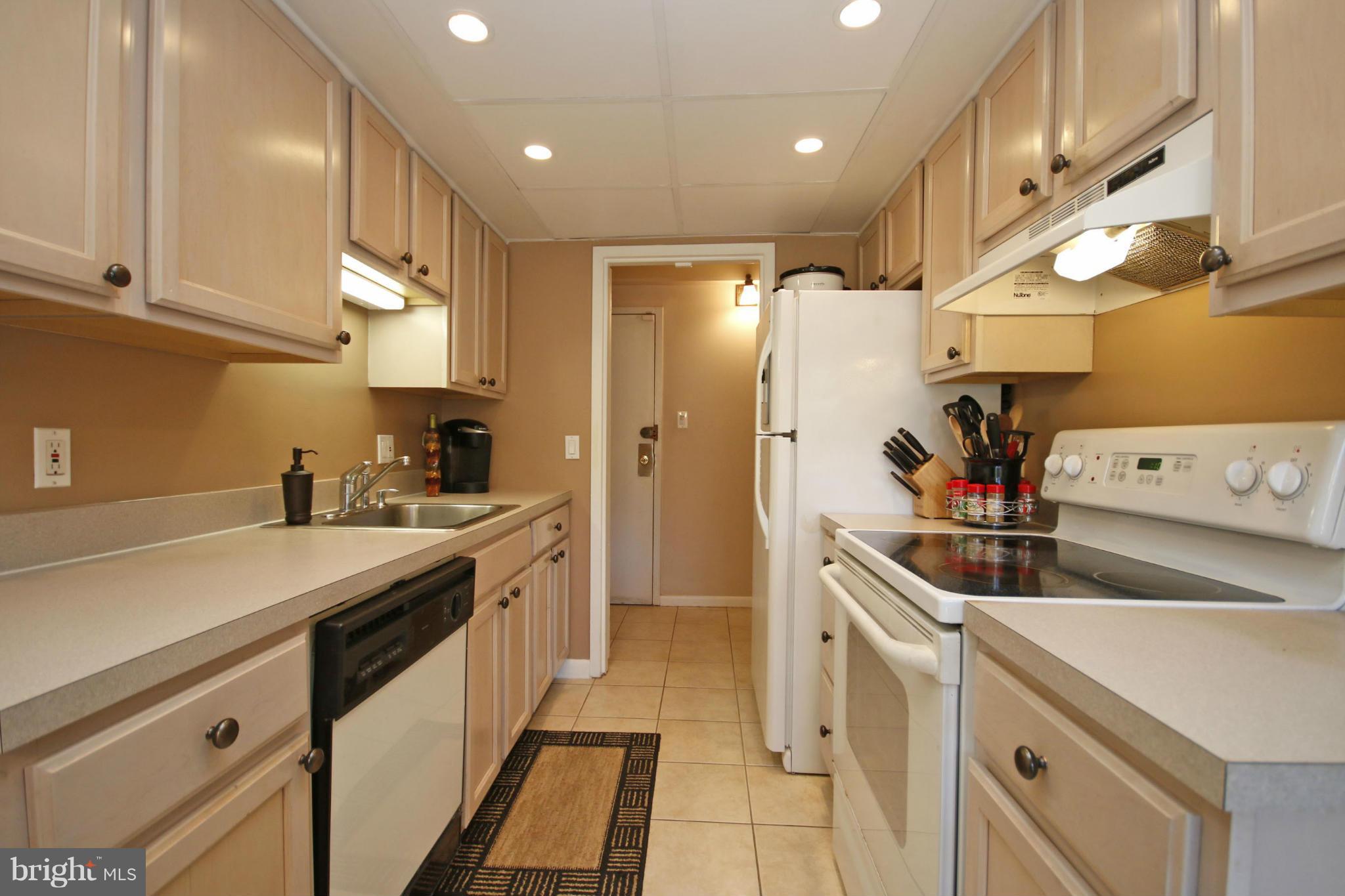 2210 Castle Rock Square, Unit 1B Reston, VA 20191 - Photo 4 of 26 a kitchen with stainless steel appliances granite countertop a sink and cabinets