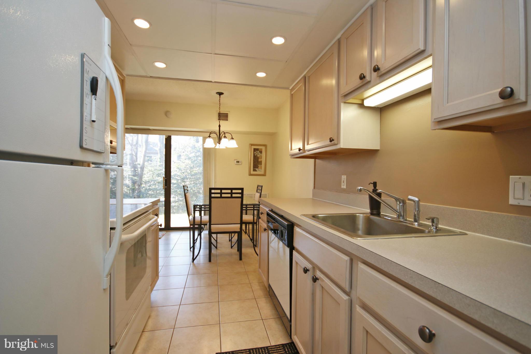 2210 Castle Rock Square, Unit 1B Reston, VA 20191 - Photo 5 of 26 a kitchen with sink cabinets and window