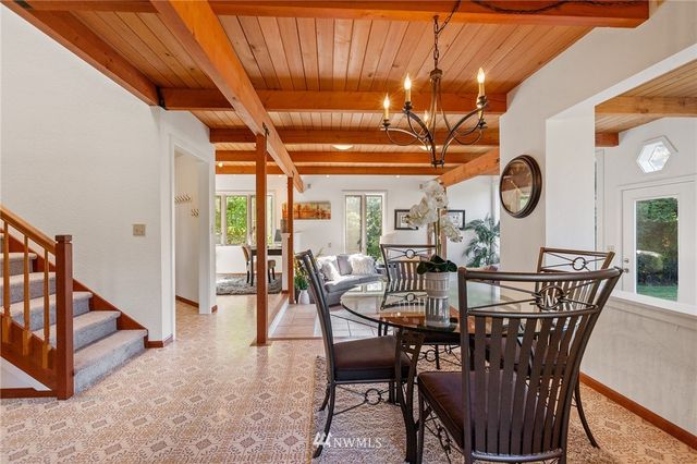 a view of a dining room with furniture and a chandelier