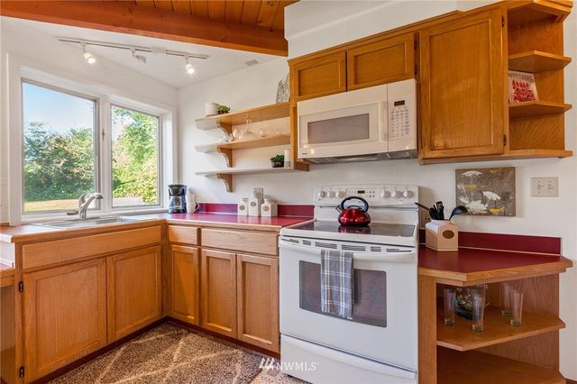 a kitchen with stainless steel appliances granite countertop a sink and cabinets