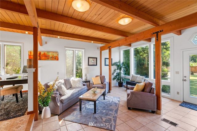 a living room with patio furniture and a large window