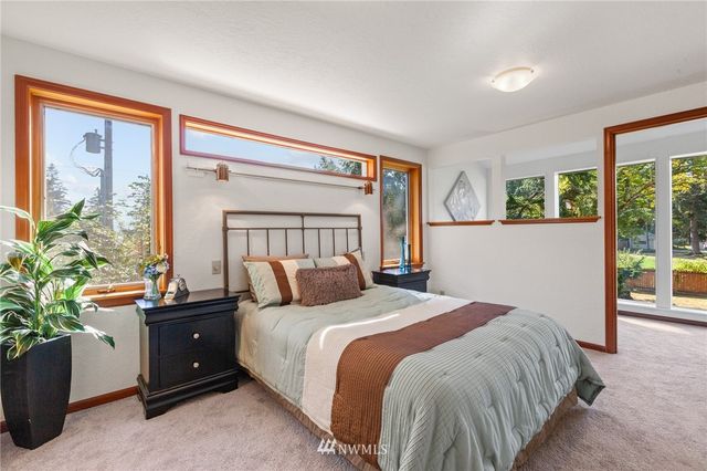 a bedroom with a bed and a potted plant