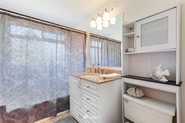 a bathroom with a sink a vanity and a mirror
