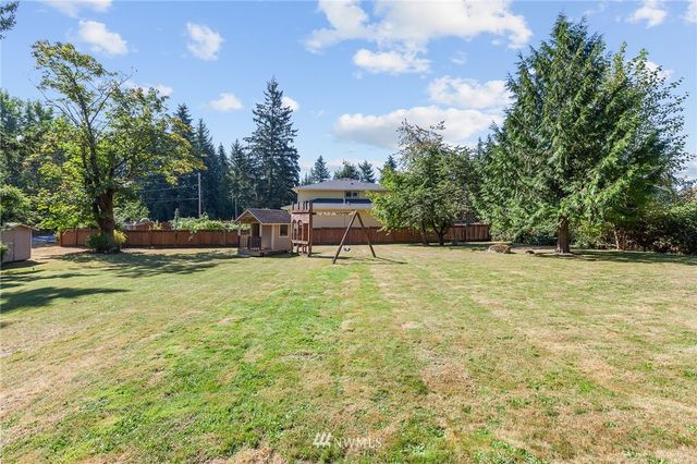 an aerial view of residential houses with outdoor space and lake view