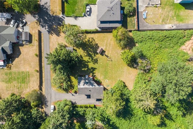 an aerial view of a residential houses with outdoor space