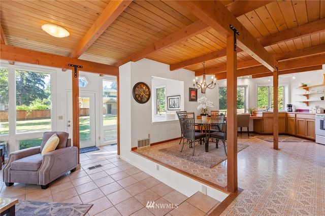 a living room filled with furniture and a large window