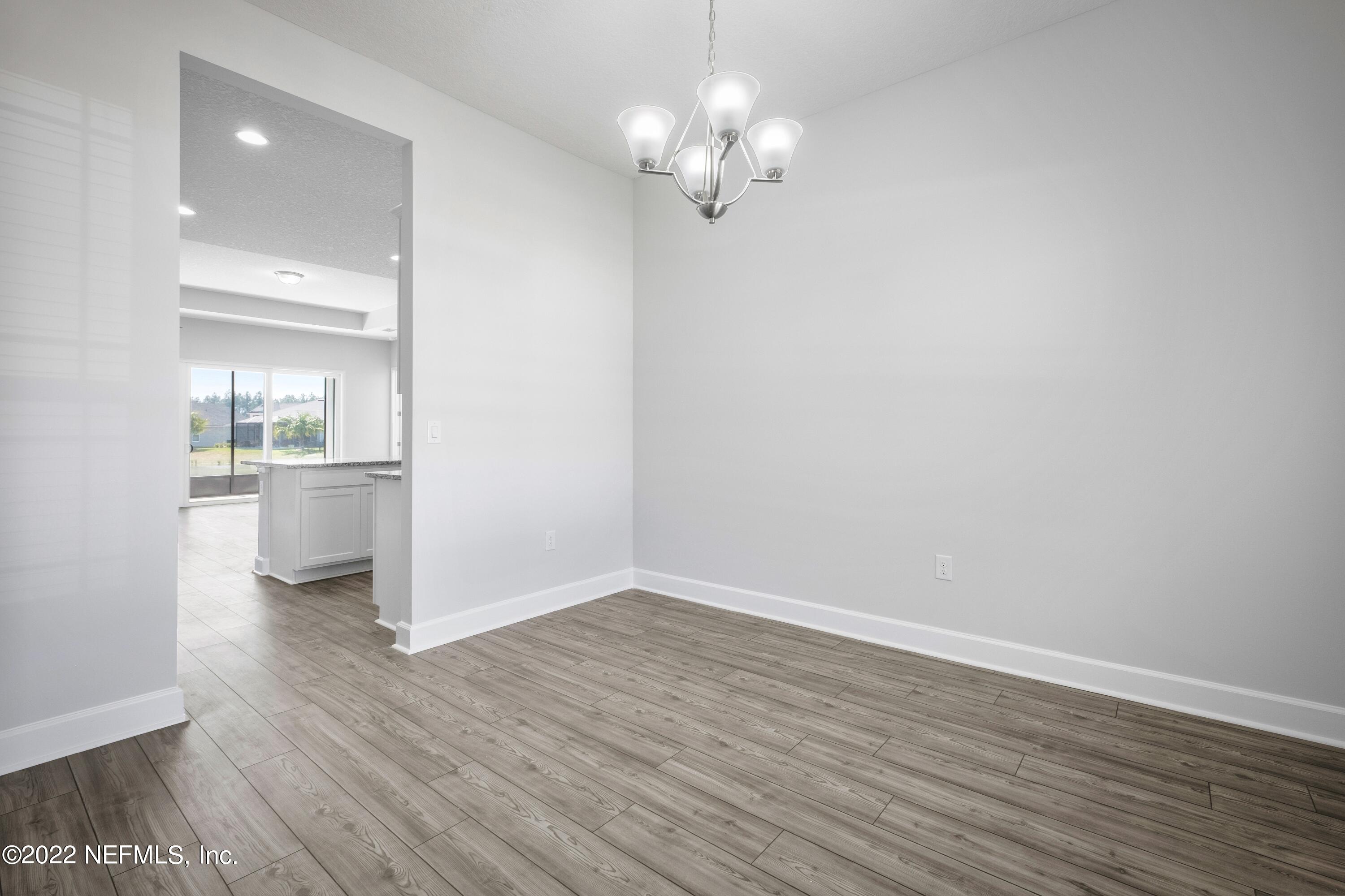 160 Daniel Creek Court St. Augustine, FL 32095 - Photo 13 of 35 a view of a room with wooden floor and a chandelier