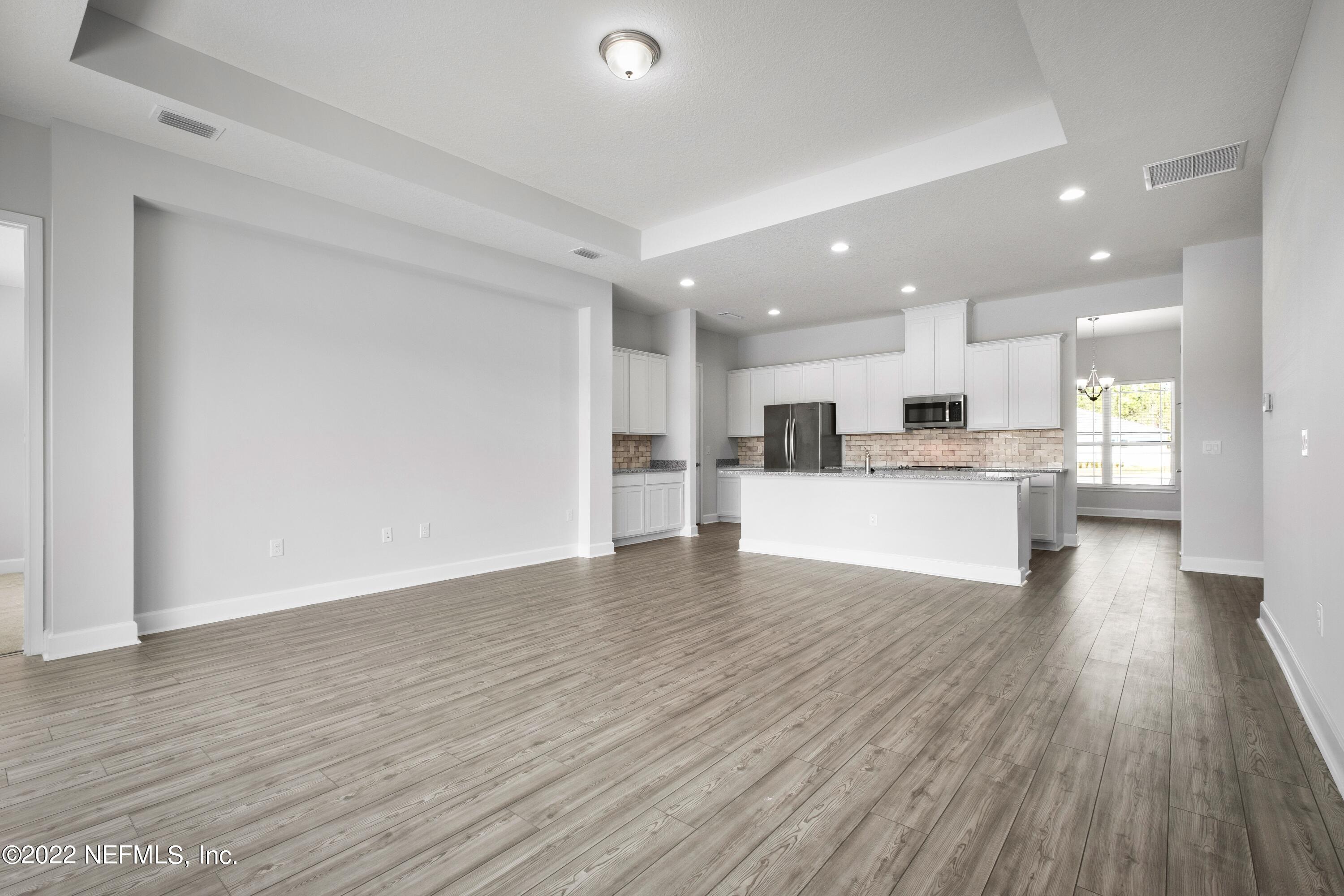 160 Daniel Creek Court St. Augustine, FL 32095 - Photo 16 of 35 a view of kitchen dining table chairs microwave and cabinets