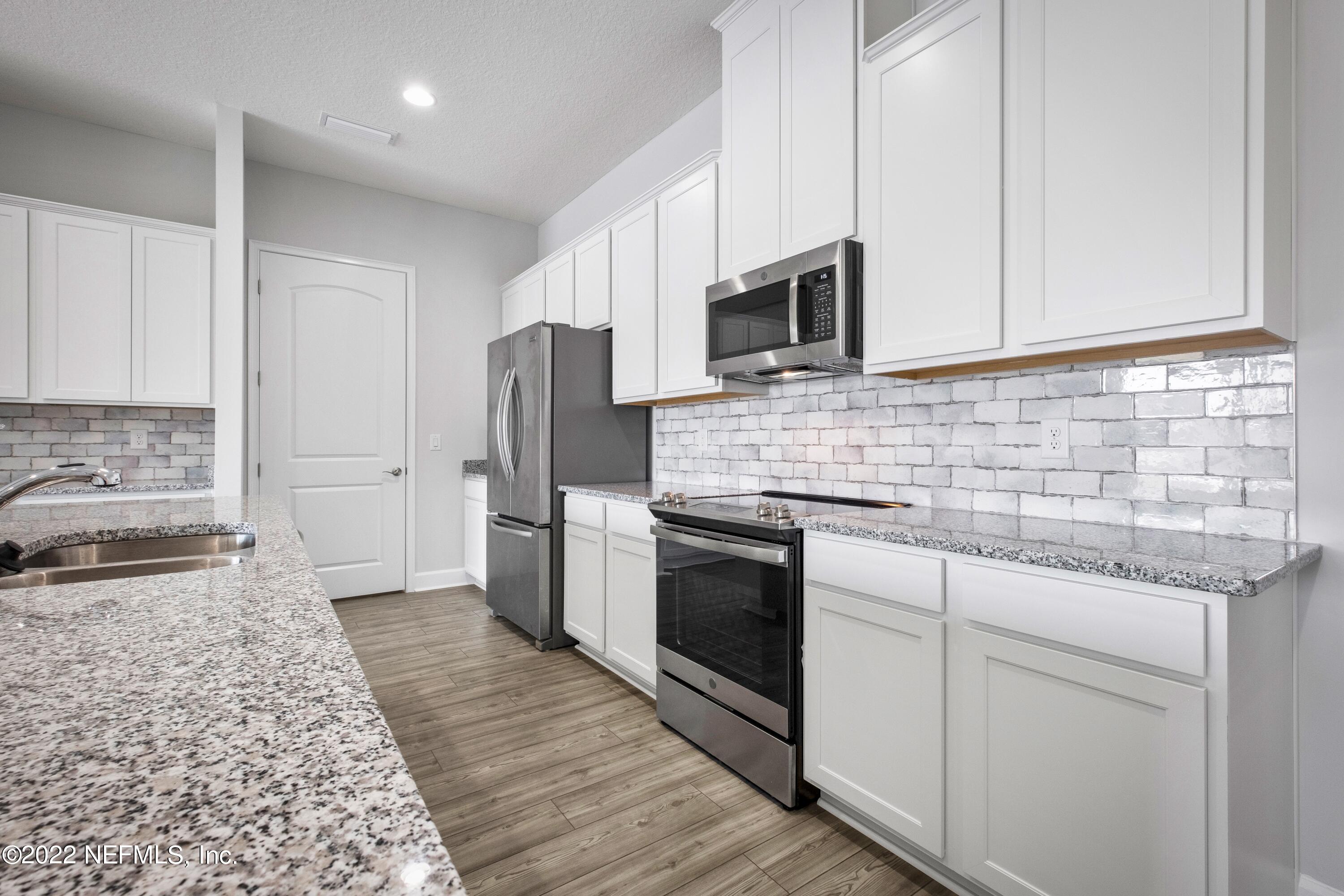 160 Daniel Creek Court St. Augustine, FL 32095 - Photo 20 of 35 a kitchen with stainless steel appliances granite countertop a stove a sink and a refrigerator