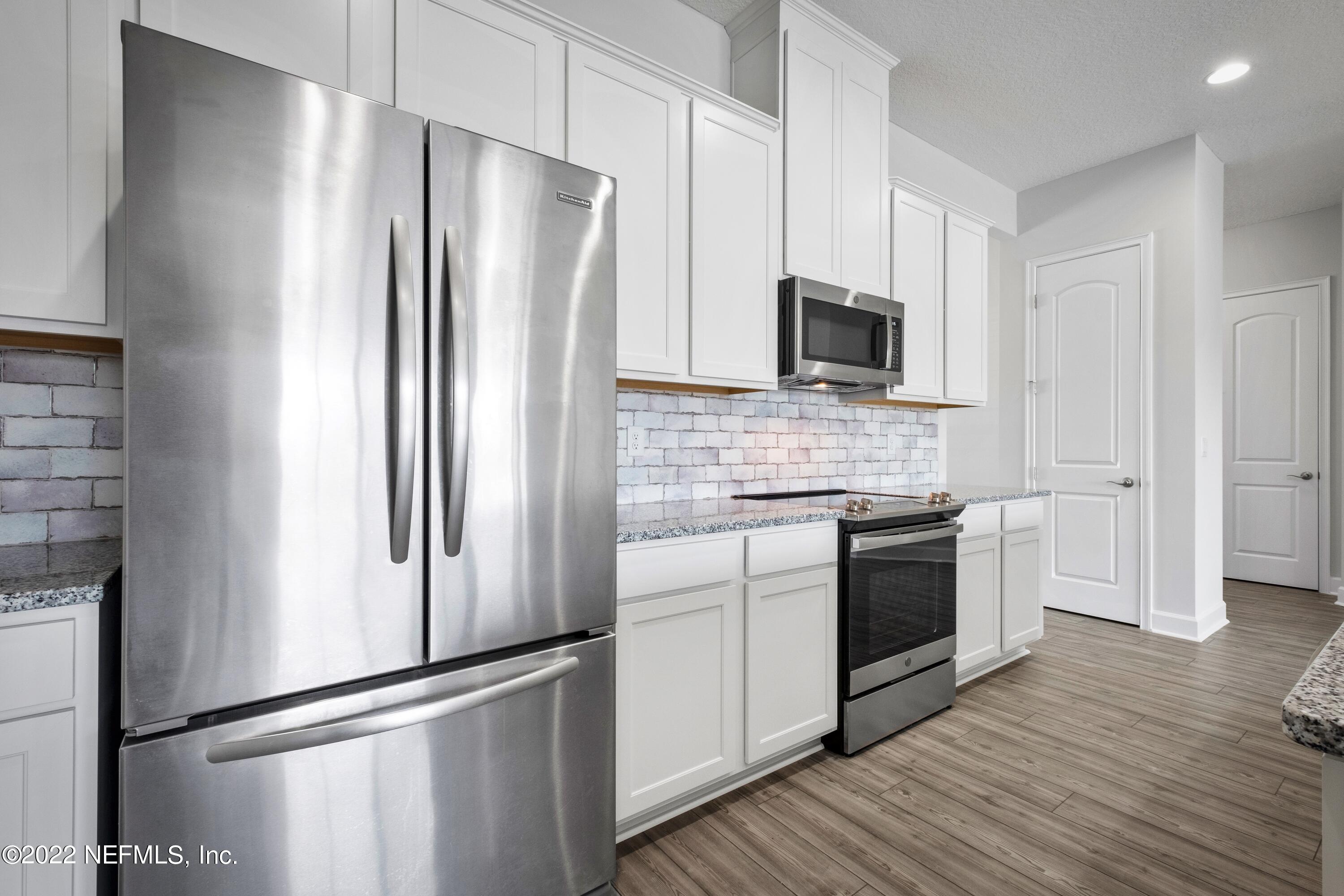 160 Daniel Creek Court St. Augustine, FL 32095 - Photo 21 of 35 a kitchen with stainless steel appliances and wooden floor