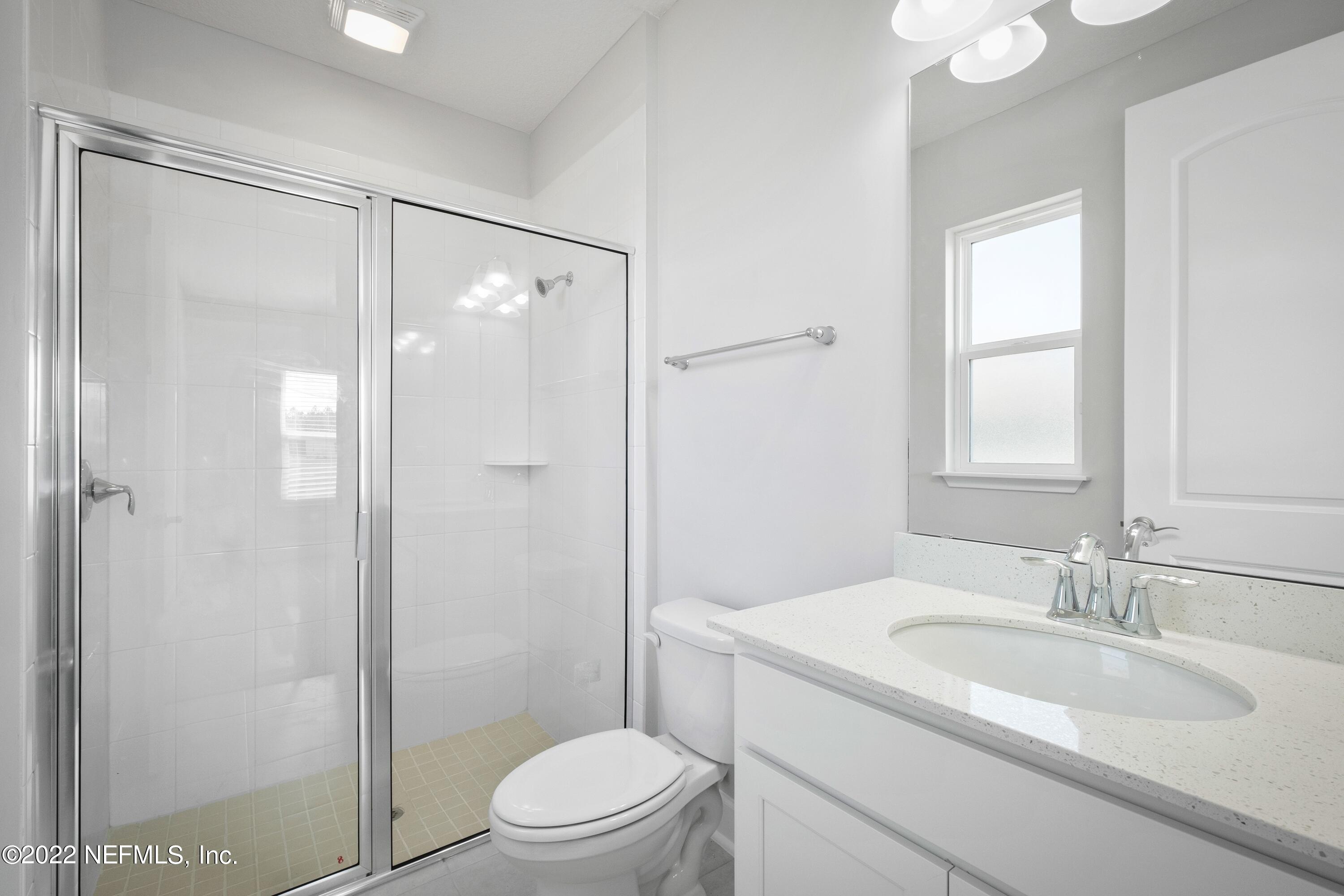 160 Daniel Creek Court St. Augustine, FL 32095 - Photo 25 of 35 a bathroom with a sink toilet vanity and shower
