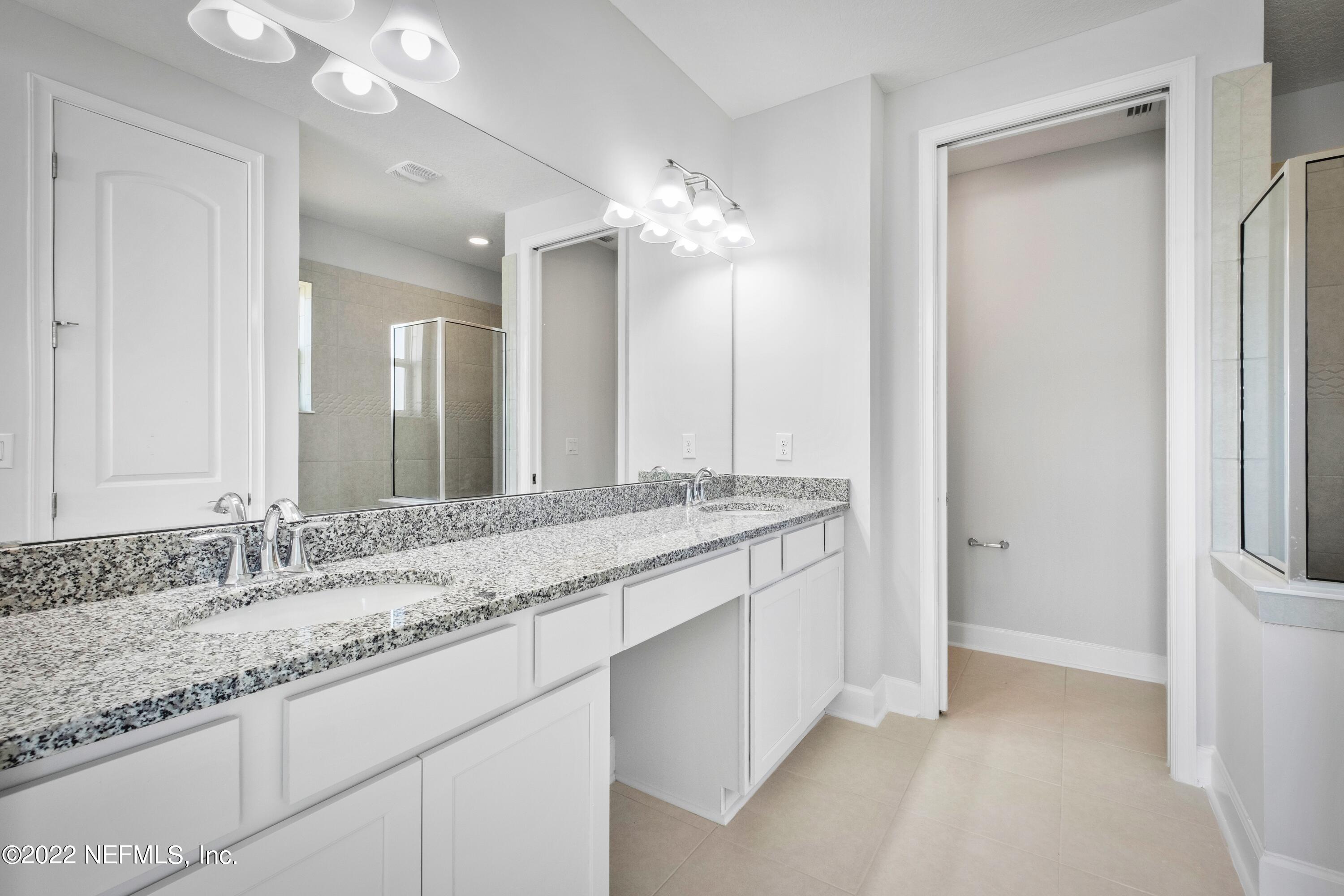 160 Daniel Creek Court St. Augustine, FL 32095 - Photo 30 of 35 a bathroom with a granite countertop sink and a mirror