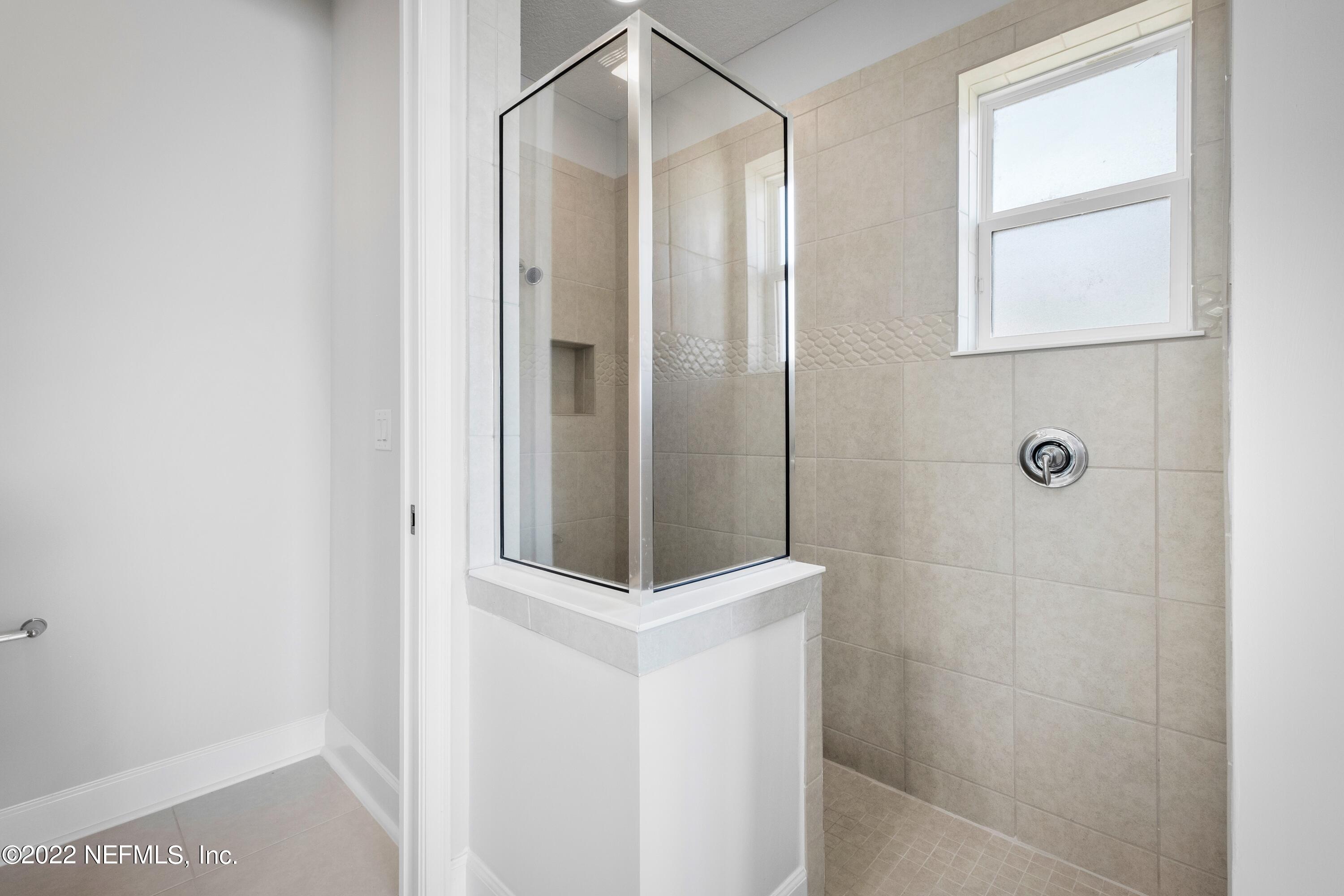 160 Daniel Creek Court St. Augustine, FL 32095 - Photo 31 of 35 a bathroom with a shower and a mirror