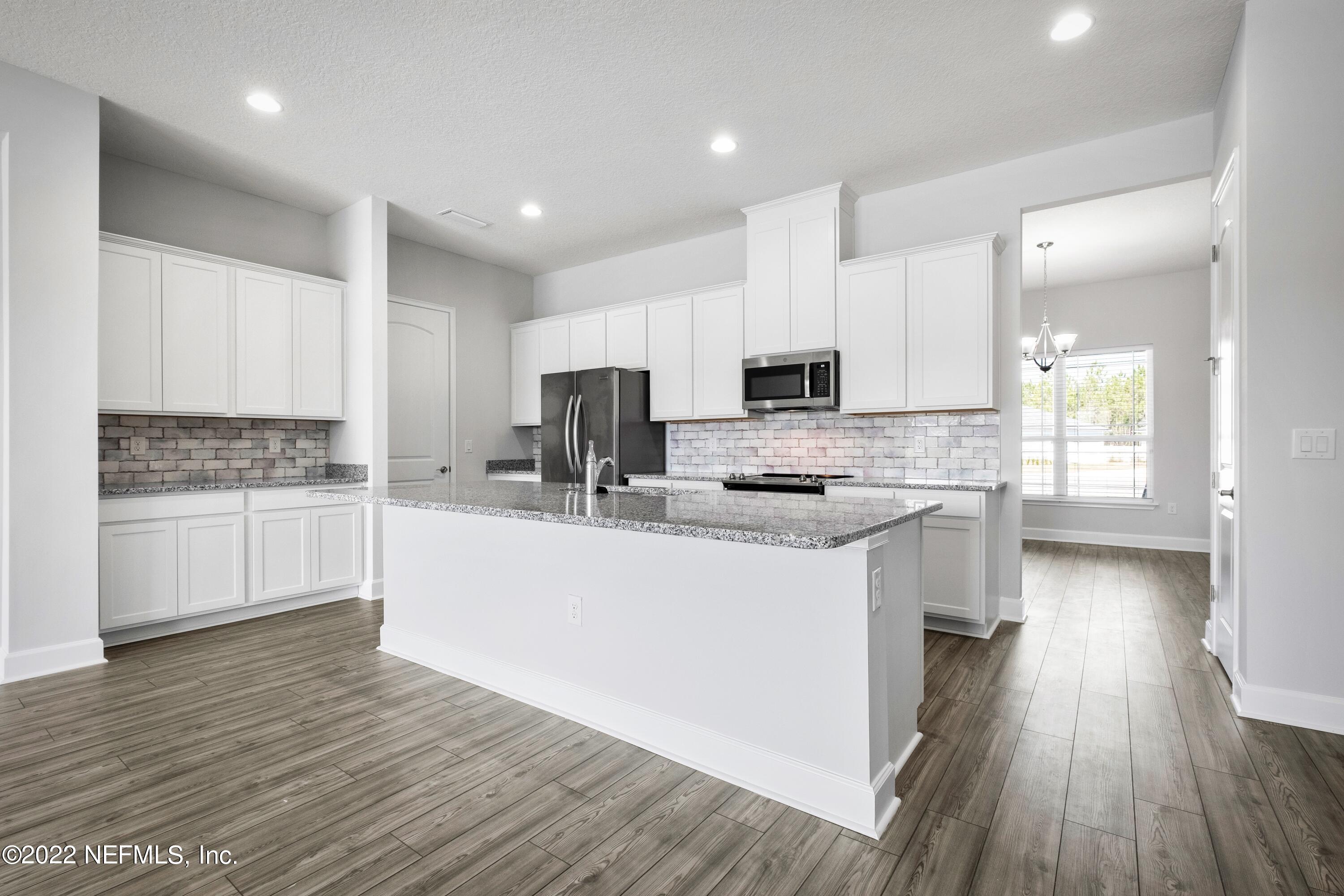 160 Daniel Creek Court St. Augustine, FL 32095 - Photo 5 of 35 a kitchen with granite countertop white cabinets and white appliances