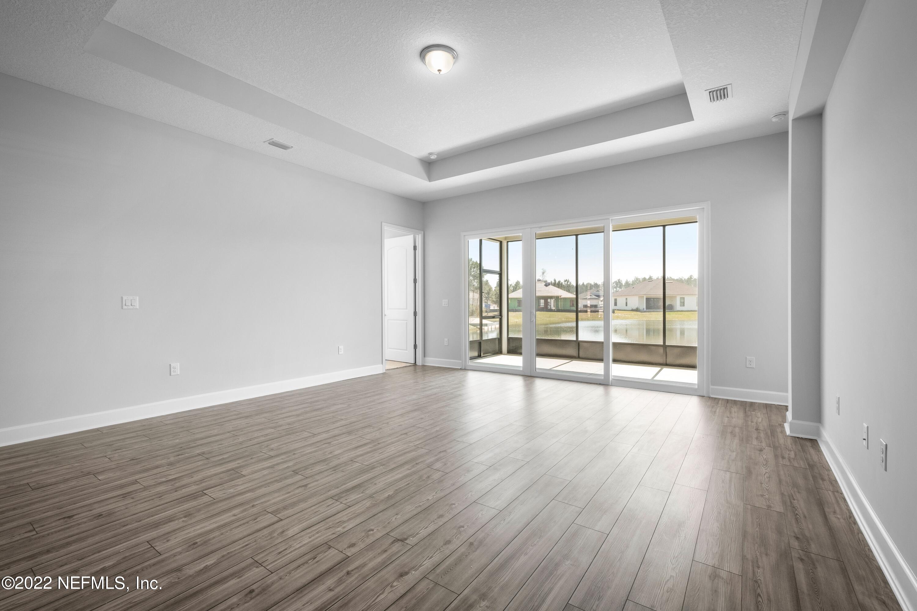 160 Daniel Creek Court St. Augustine, FL 32095 - Photo 6 of 35 wooden floor in an empty room with a window
