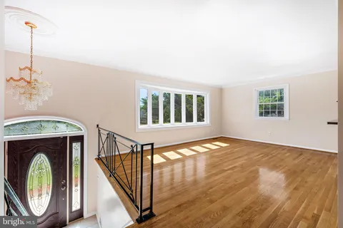 a view of an empty room with a fireplace and a window