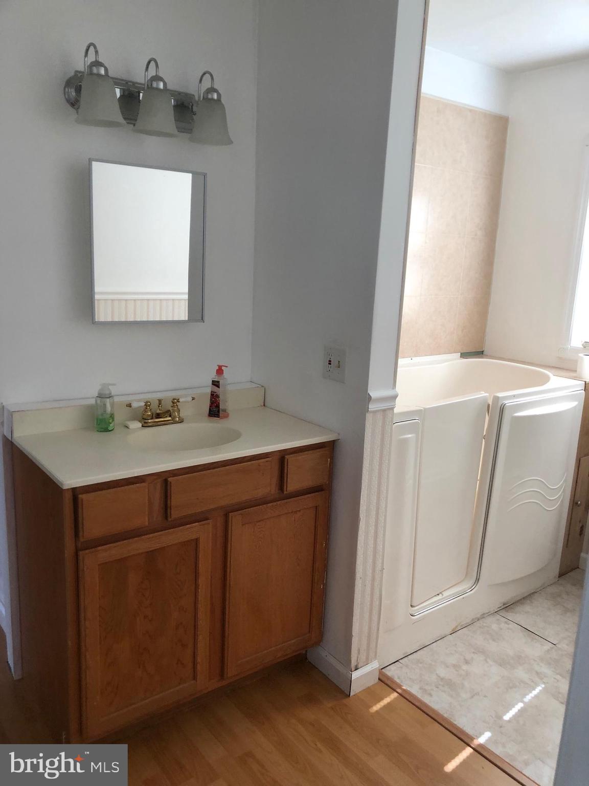 1304 Garrison Road Vineland, NJ 08360 - Photo 15 of 36 a bathroom with a sink a mirror and vanity