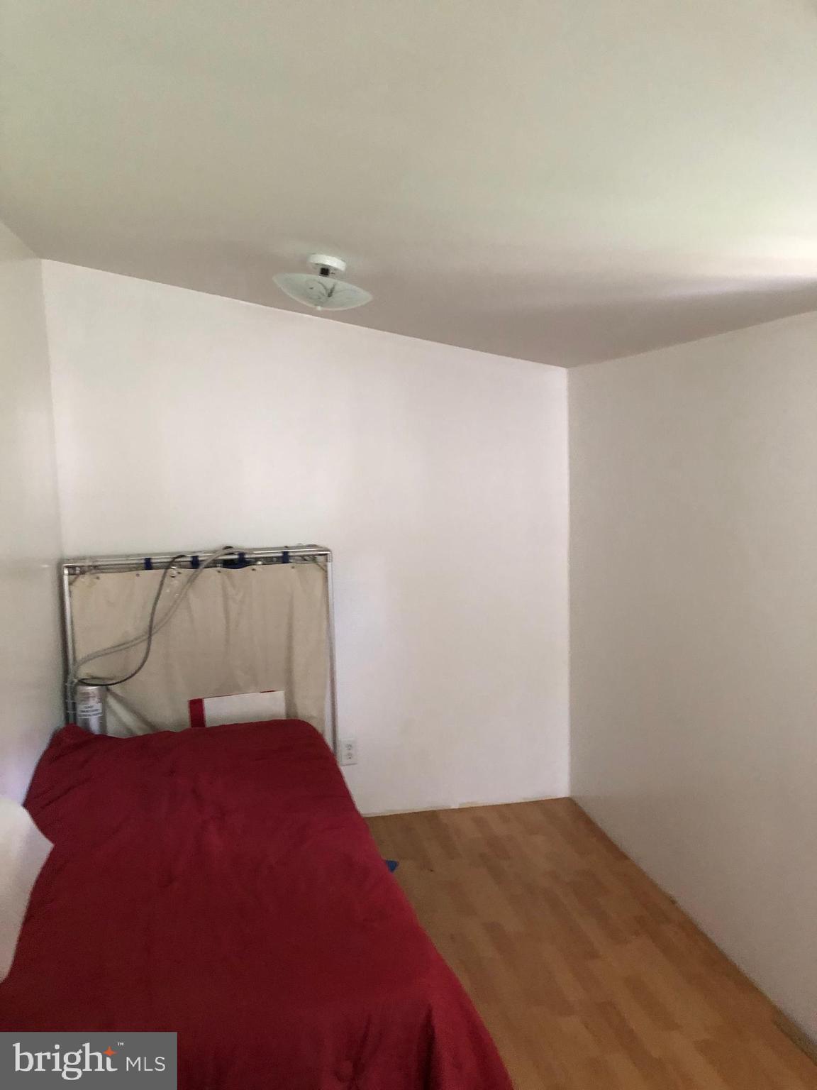 1304 Garrison Road Vineland, NJ 08360 - Photo 8 of 36 a bed sitting in a bedroom next to a lamp