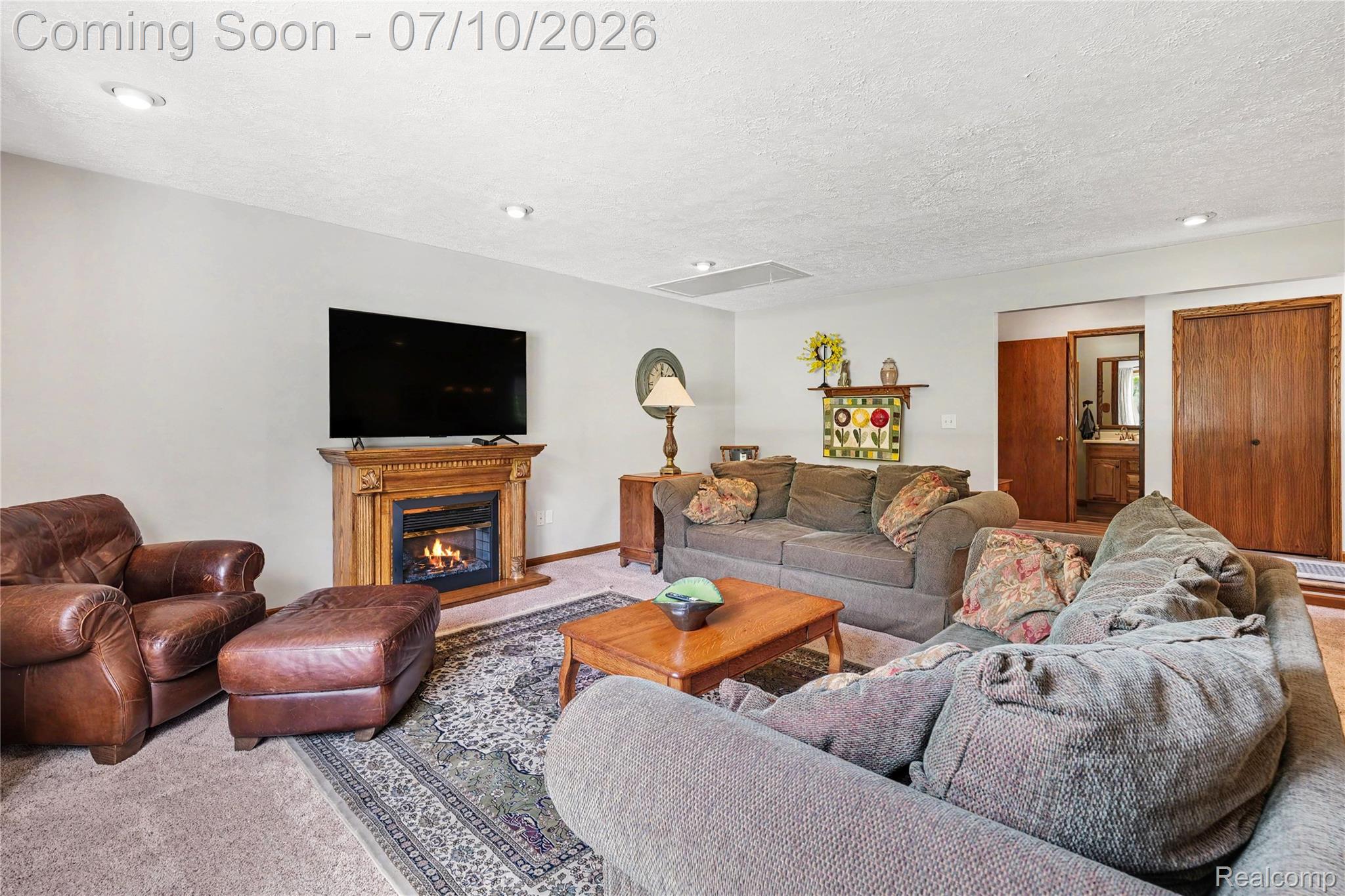2180 Hurst Road St. Clair, MI 48079 - Photo 8 of 39 Spacious living area featuring a decorative wood mantel and an electric fireplace insert