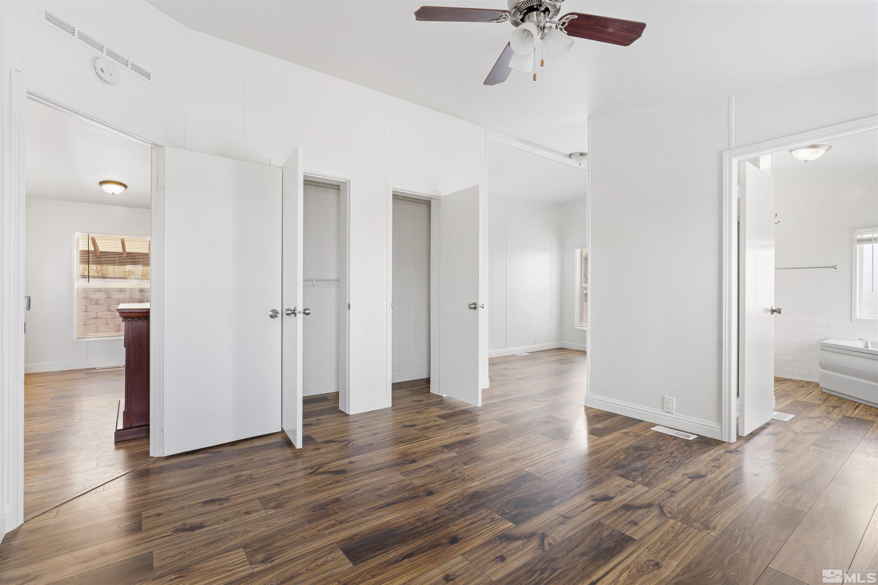 16000 Perlite Drive Reno, NV 89521 - Photo 11 of 29 a view of a hallway with wooden floor and a ceiling fan