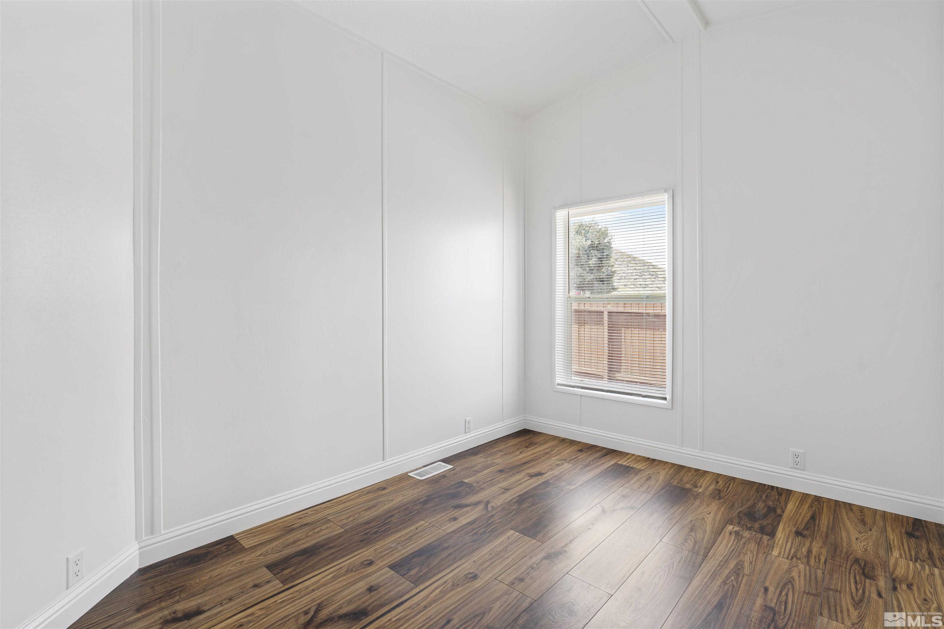 16000 Perlite Drive Reno, NV 89521 - Photo 13 of 29 an empty room with wooden floor and windows