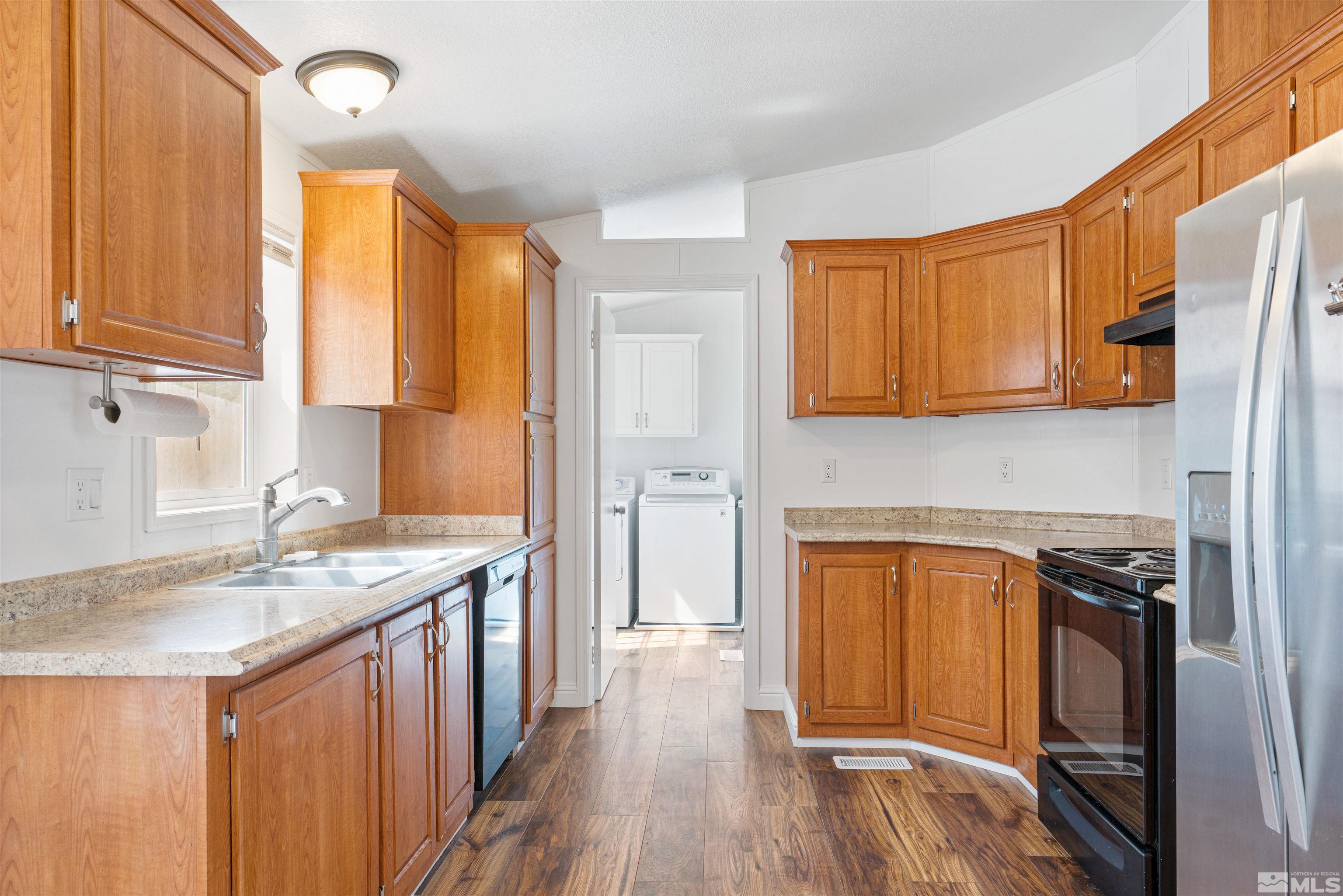 16000 Perlite Drive Reno, NV 89521 - Photo 6 of 29 a kitchen with a sink a stove cabinets and wooden floor