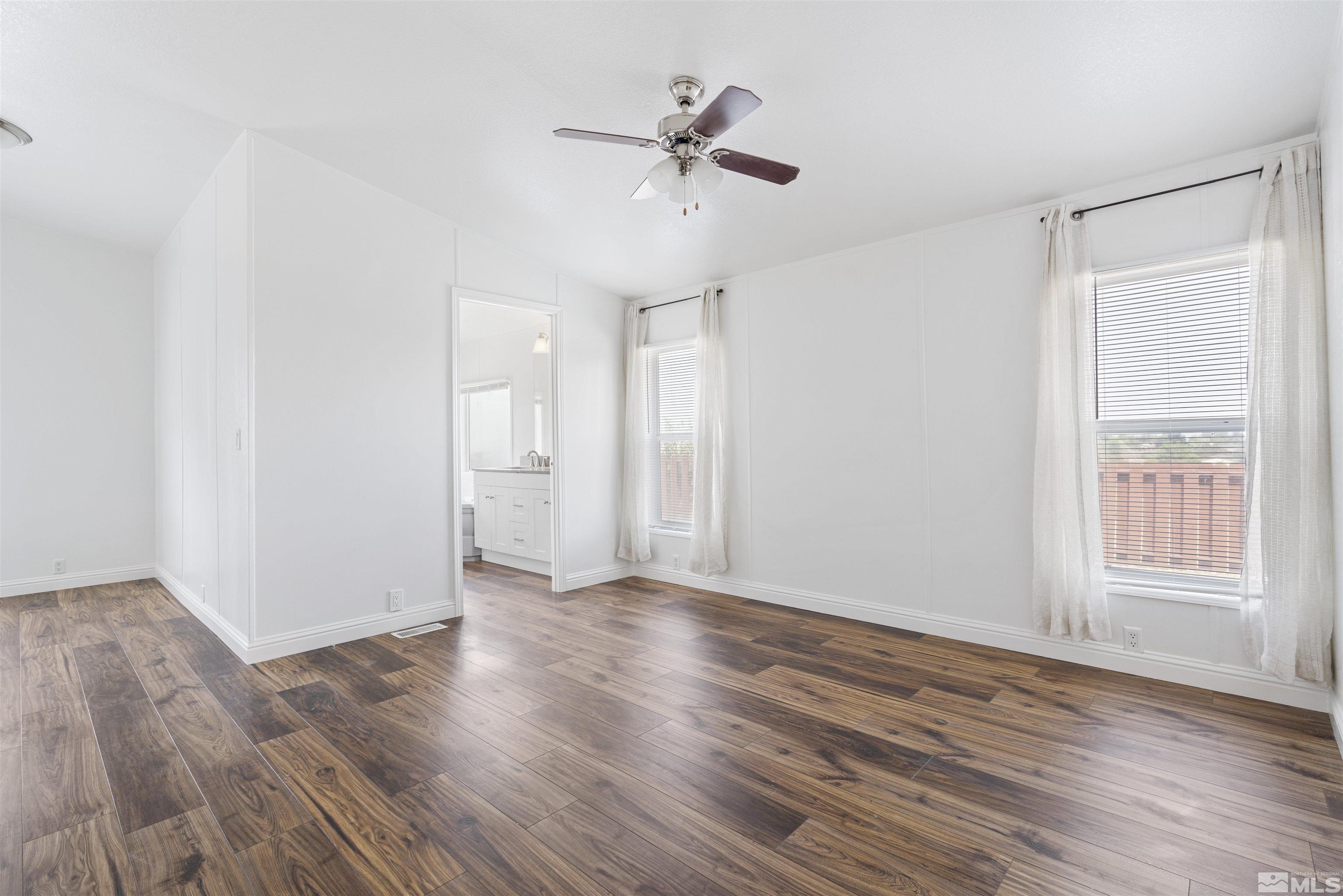 16000 Perlite Drive Reno, NV 89521 - Photo 10 of 29 a view of an empty room with a window and wooden floor