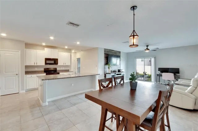a kitchen with stainless steel appliances kitchen island granite countertop a stove and a sink
