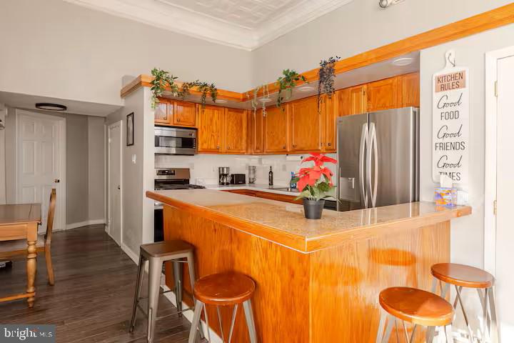 a kitchen with stainless steel appliances granite countertop a sink and a refrigerator