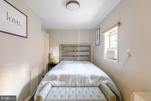 a bedroom with a bed and a window