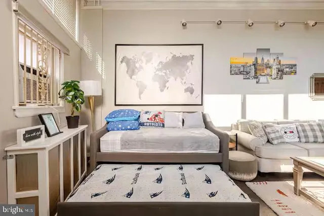 a view of a bedroom with furniture and windows