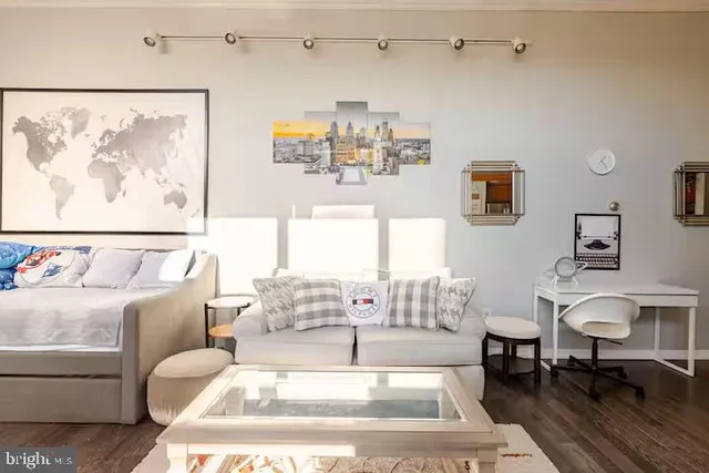 a living room with furniture and a painting