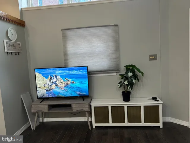 a view of a room with furniture and wooden floor