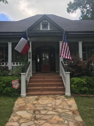 a view of a chair and table in backyard of the house