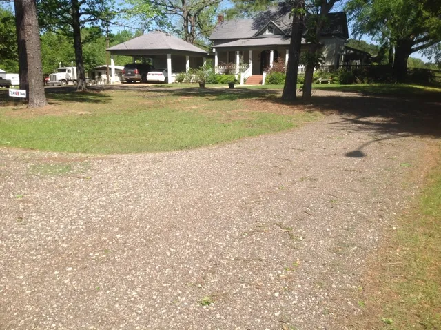 a front view of a house with yard covered in snow