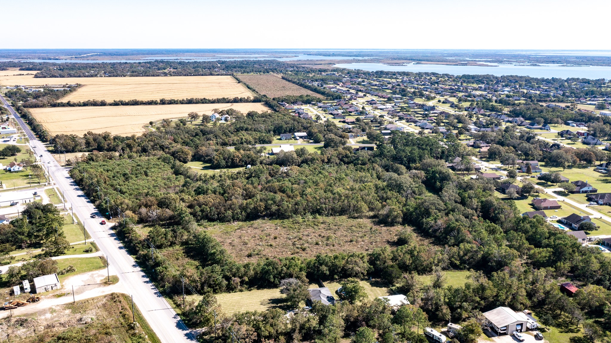 5610 South Farm-to-Market 565 Road Baytown, TX 77523 - Photo 13 of 20 an aerial view of a house with a yard and lake view