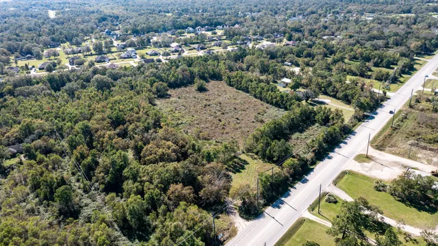 an aerial view of a houses with a yard