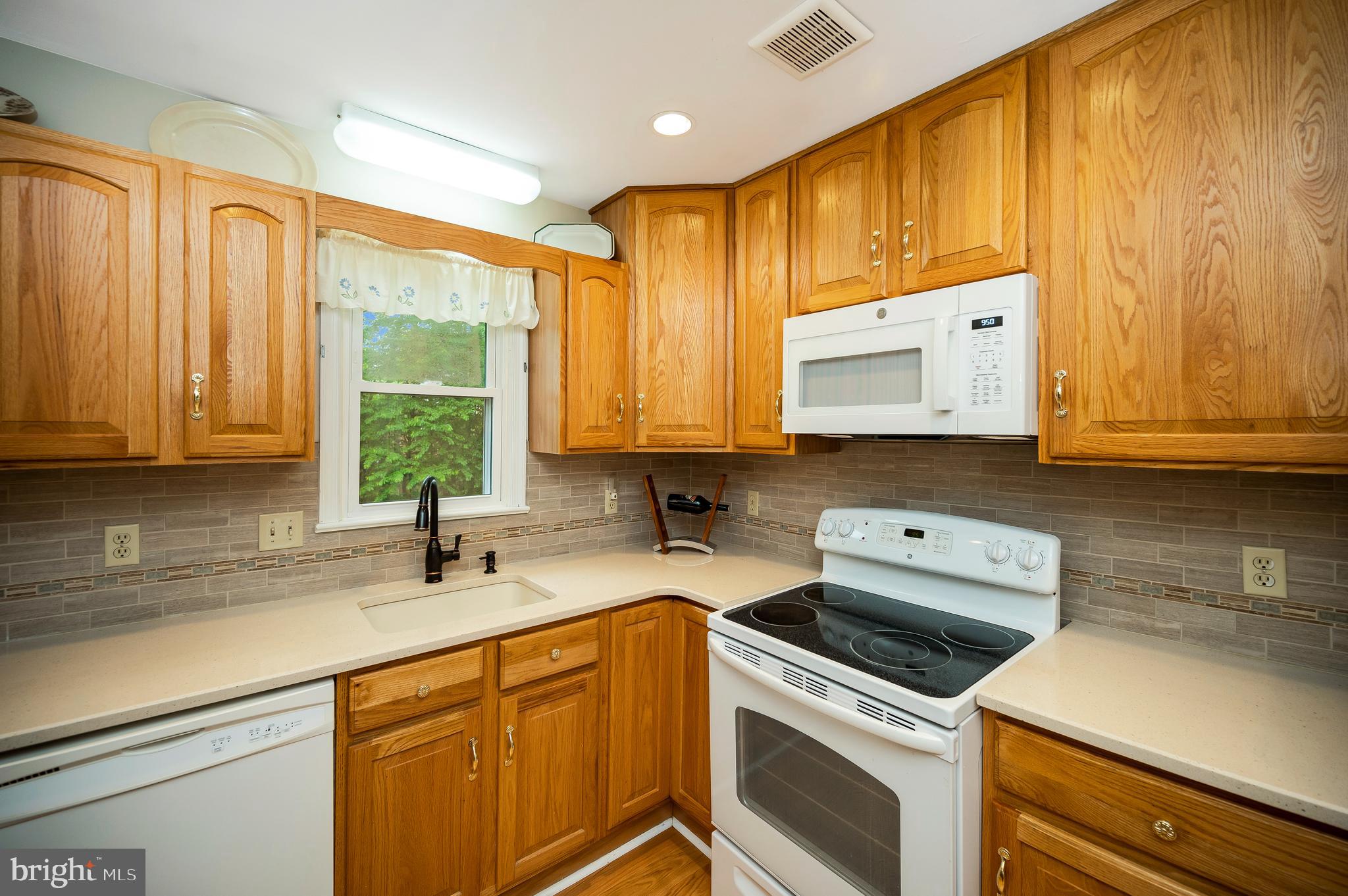 14 Apache Terrace Fredericksburg, VA 22401 - Photo 9 of 38 a kitchen with stainless steel appliances a stove a sink and a microwave