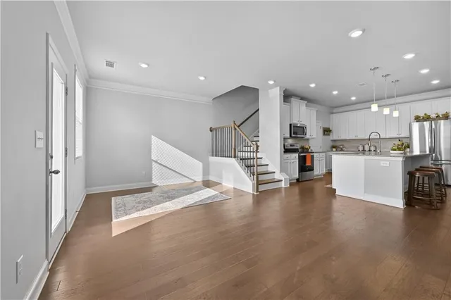a view of kitchen with cabinets and refrigerator
