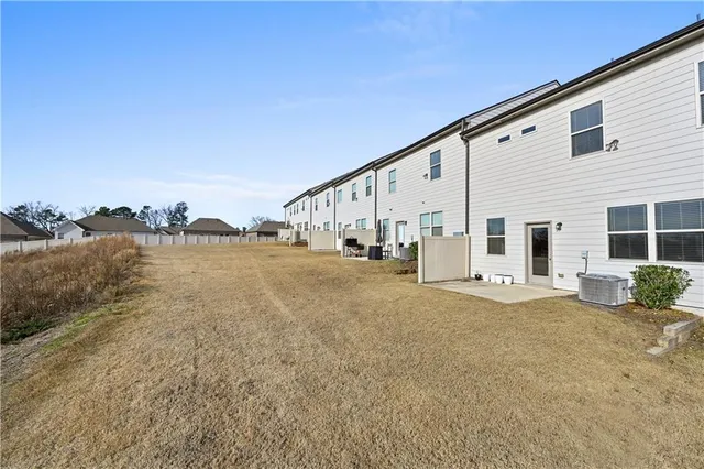 a view of a house with backyard and ocean view
