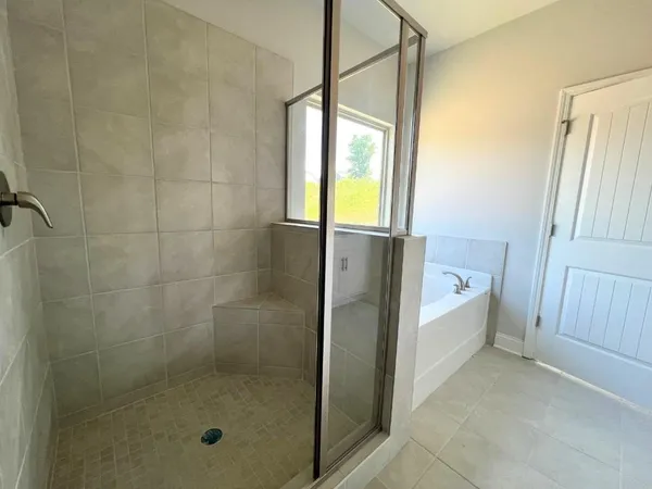 a bathroom with a bathtub and shower