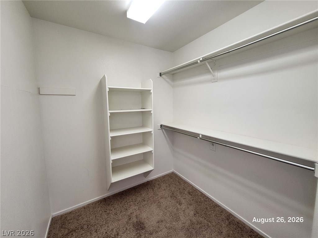 994 Broken Reed Court Henderson, NV 89015 - Photo 16 of 18 Ample hanging rods and built-in shelving maximize storage capacity in this carpeted closet.