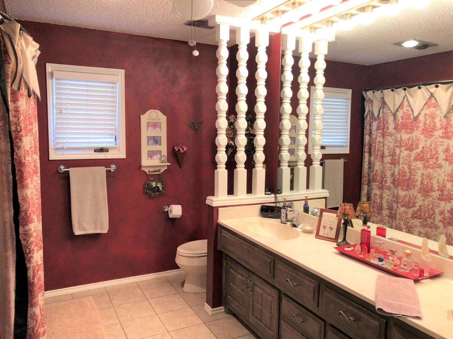 4018 88th Place Lubbock, TX 79423 - Photo 26 of 31 a bathroom with a sink a toilet and a mirror