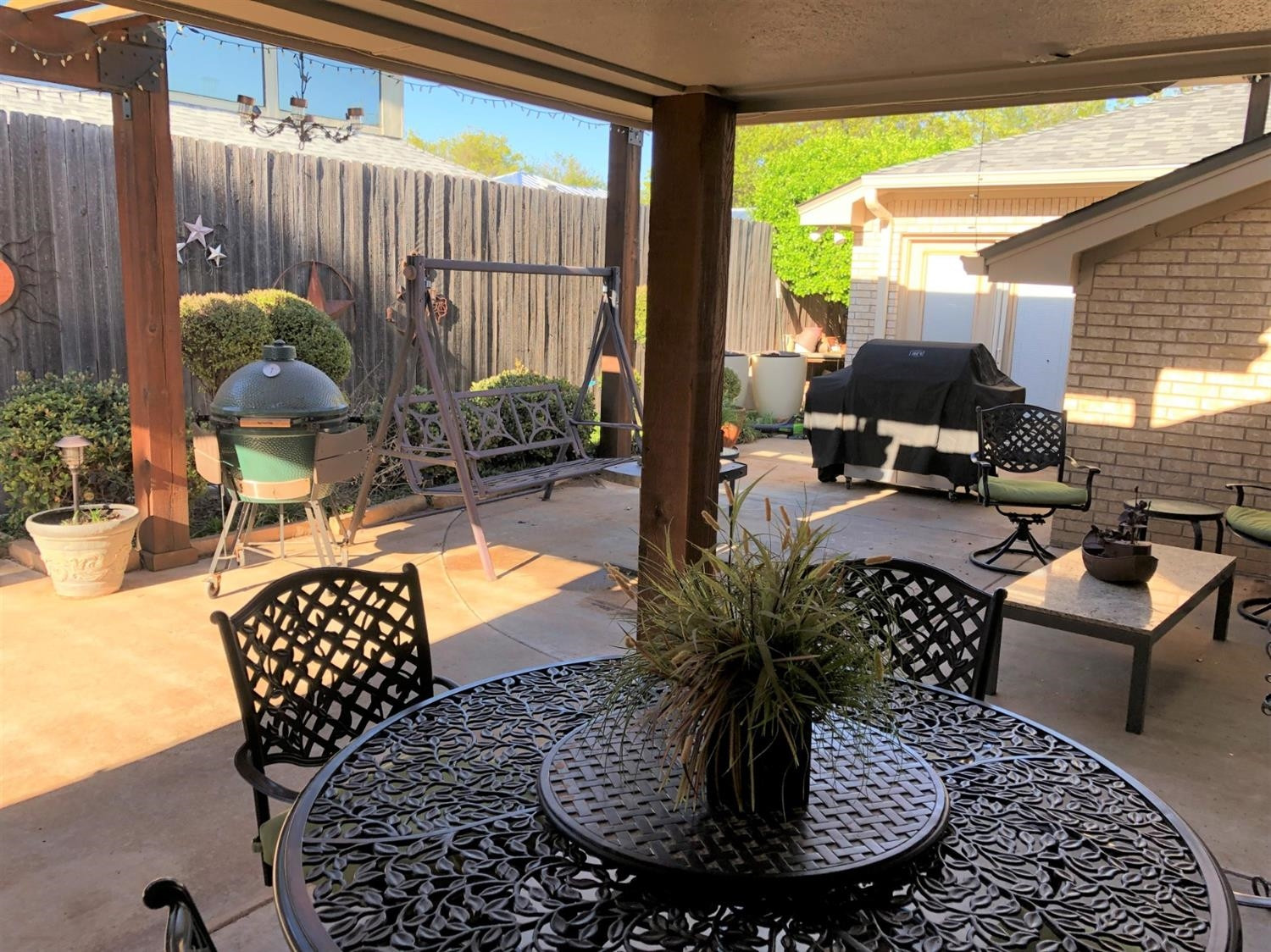 4018 88th Place Lubbock, TX 79423 - Photo 28 of 31 a view of a patio with a table chairs and a potted plant