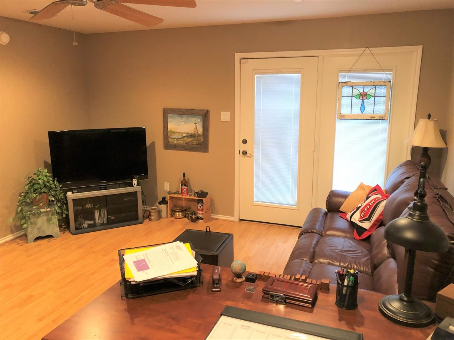 4018 88th Place Lubbock, TX 79423 - Photo 30 of 31 a living room with furniture and a flat screen tv