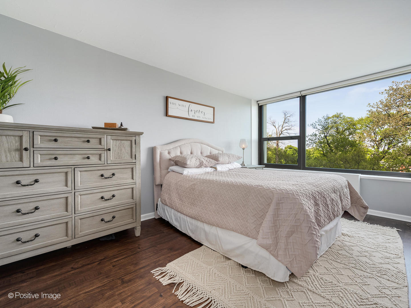 1850 North Clark Street, Unit 407 Chicago, IL 60614 - Photo 13 of 23 a bedroom with a bed and a potted plant on dresser
