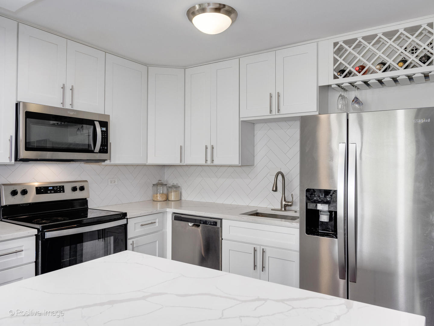 1850 North Clark Street, Unit 407 Chicago, IL 60614 - Photo 10 of 23 a kitchen with stainless steel appliances a refrigerator sink and cabinets