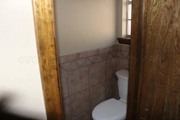 a bathroom with a toilet and a shower curtain