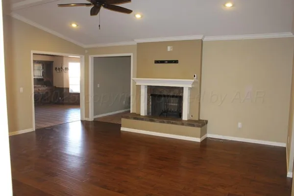 a living room with hard wood floors and a fireplace