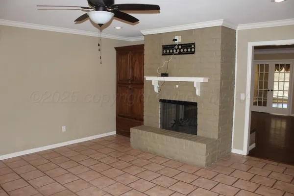 a view of a livingroom with a fireplace and window